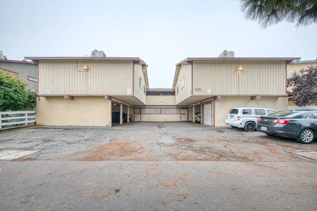 a couple of cars parked in front of a house