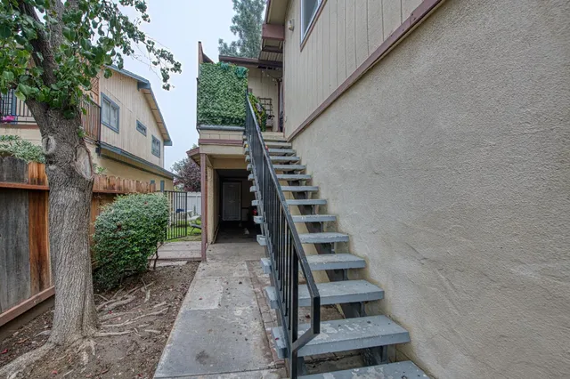 a view of staircase with wooden door and stairs
