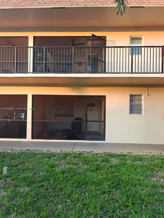 a view of swimming pool with a yard in front of it