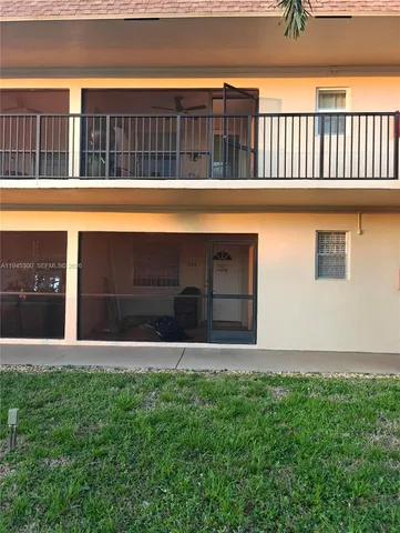 a view of swimming pool with a yard in front of it