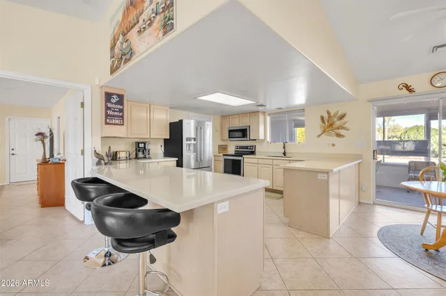 a kitchen with stainless steel appliances kitchen island granite countertop a sink and cabinets