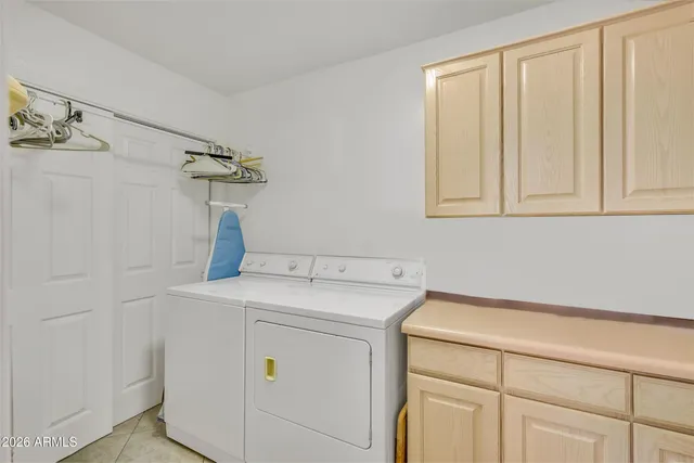 a spacious bedroom with a bed and a flat screen tv