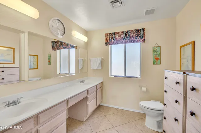 a spacious bathroom with a tub sink and mirror