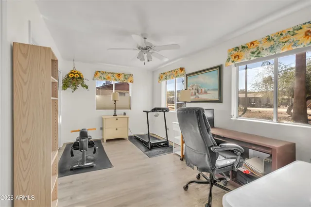 a workspace with wooden floor and furniture