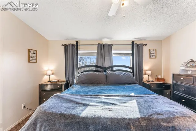 a bedroom with a bed and dresser with mirror