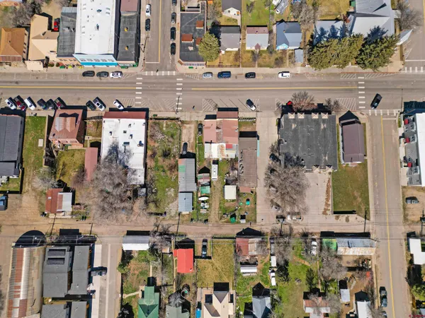 an aerial view of a house with garden space and street view
