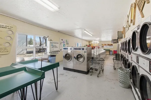 a utility room with multiple dryer and washer