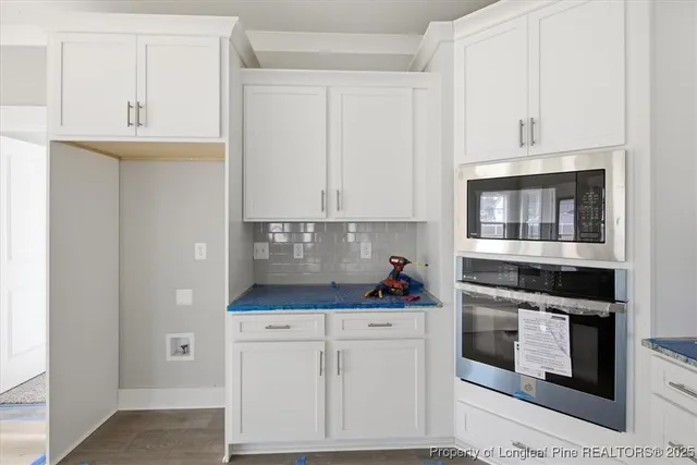 a view of an empty room with closet and a window