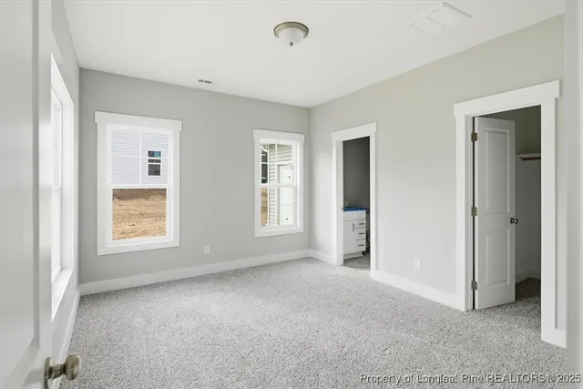 a bathroom with a granite countertop sink mirror vanity and toilet