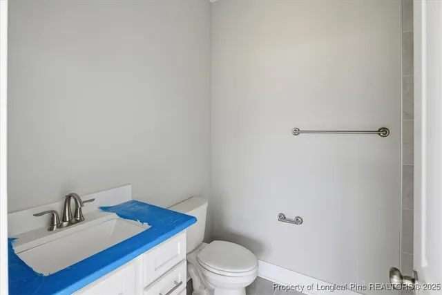 a bathroom with a granite countertop shower and a toilet