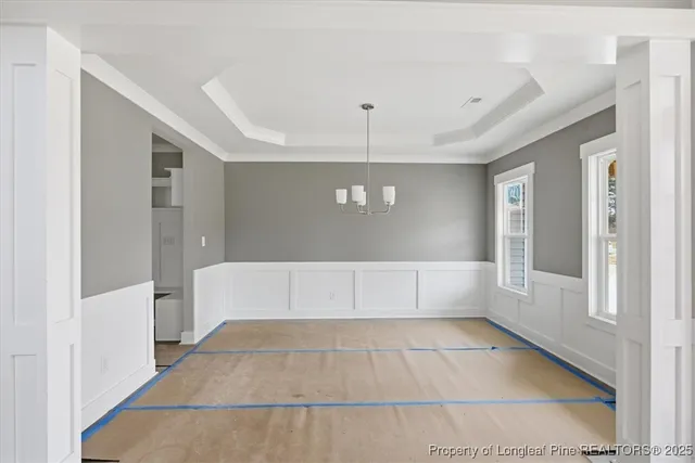 a kitchen with stainless steel appliances granite countertop a stove and a white cabinets
