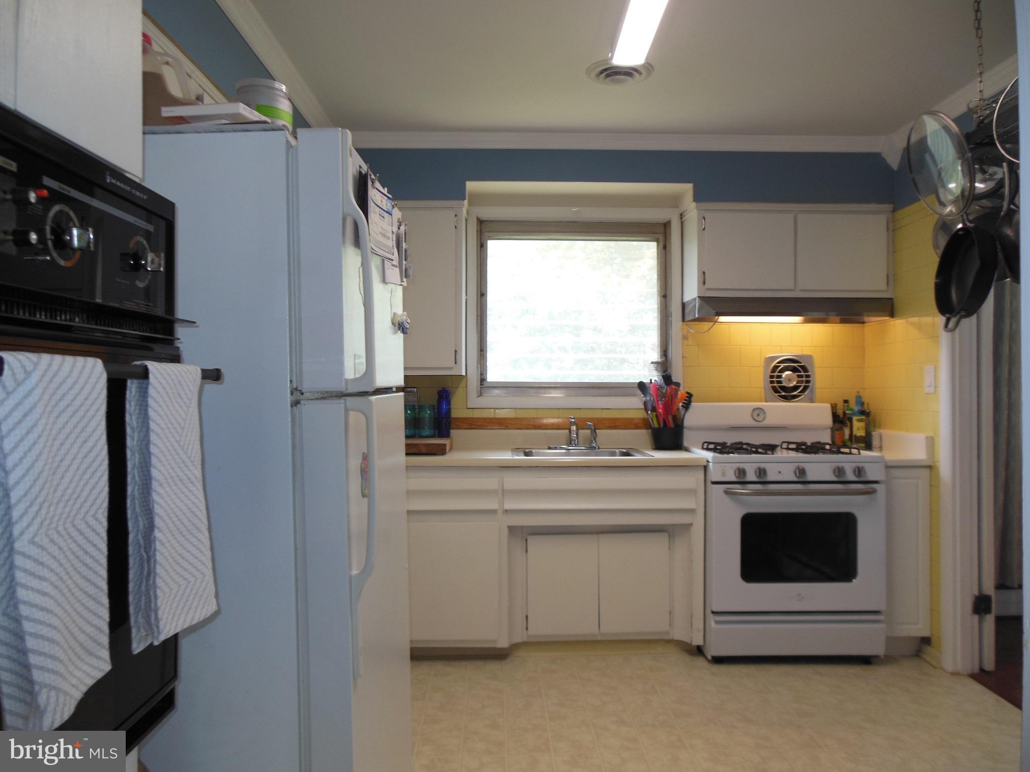 8435 Coco Road Baltimore, MD 21237 - Photo 14 of 27 a kitchen with a stove and a refrigerator