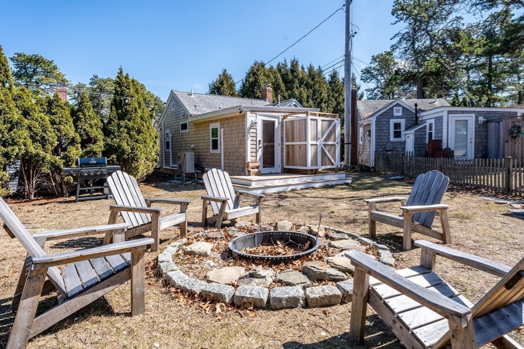 17 Ploughed Neck Road Sandwich, MA 02537 - Photo 12 of 13 a patio with a table and chairs and potted plants