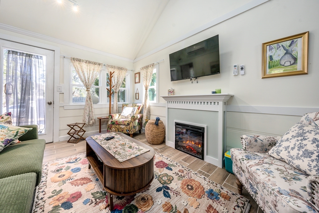 17 Ploughed Neck Road Sandwich, MA 02537 - Photo 3 of 13 a living room with furniture a flat screen tv and a fireplace