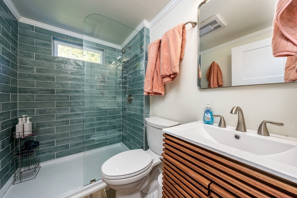 17 Ploughed Neck Road Sandwich, MA 02537 - Photo 9 of 13 a bathroom with a sink a toilet and shower curtain