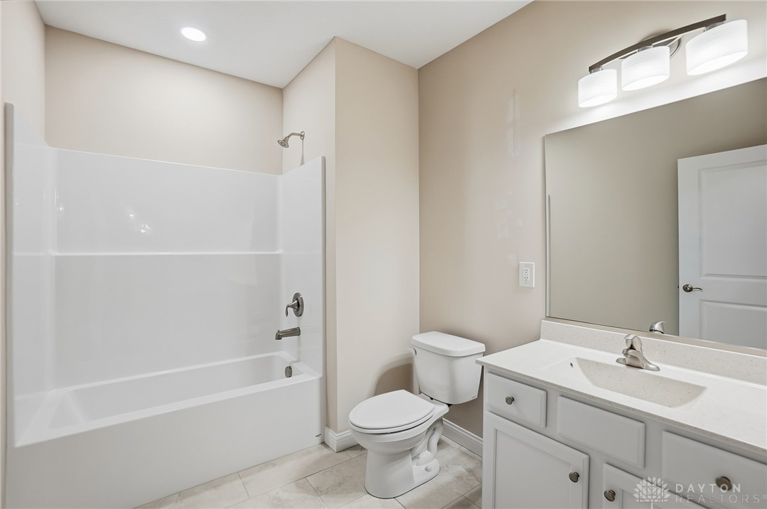 4600 Beal Road Franklin, OH 45005 - Photo 34 of 42 This bright bathroom features a vanity, modern toilet, and a combination shower-tub.