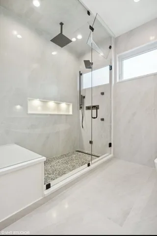 a bathroom with a shower and a sink