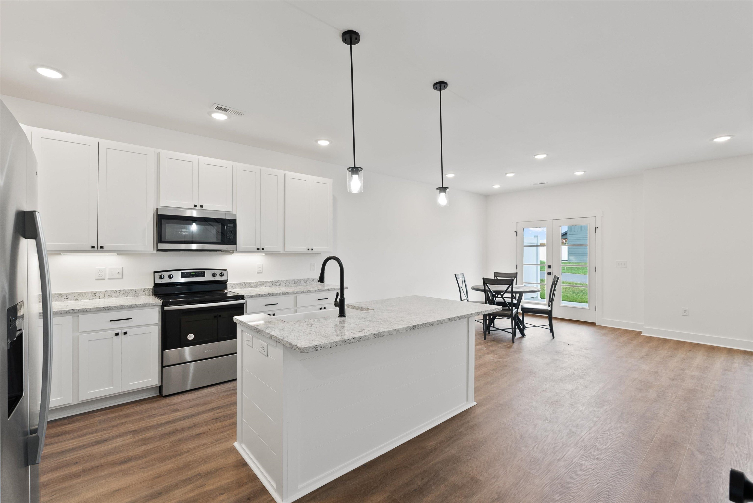 25 Barnyard Circle Bridgewater, VA 22812 - Photo 27 of 45 a kitchen with stainless steel appliances granite countertop a sink a stove and a wooden floors