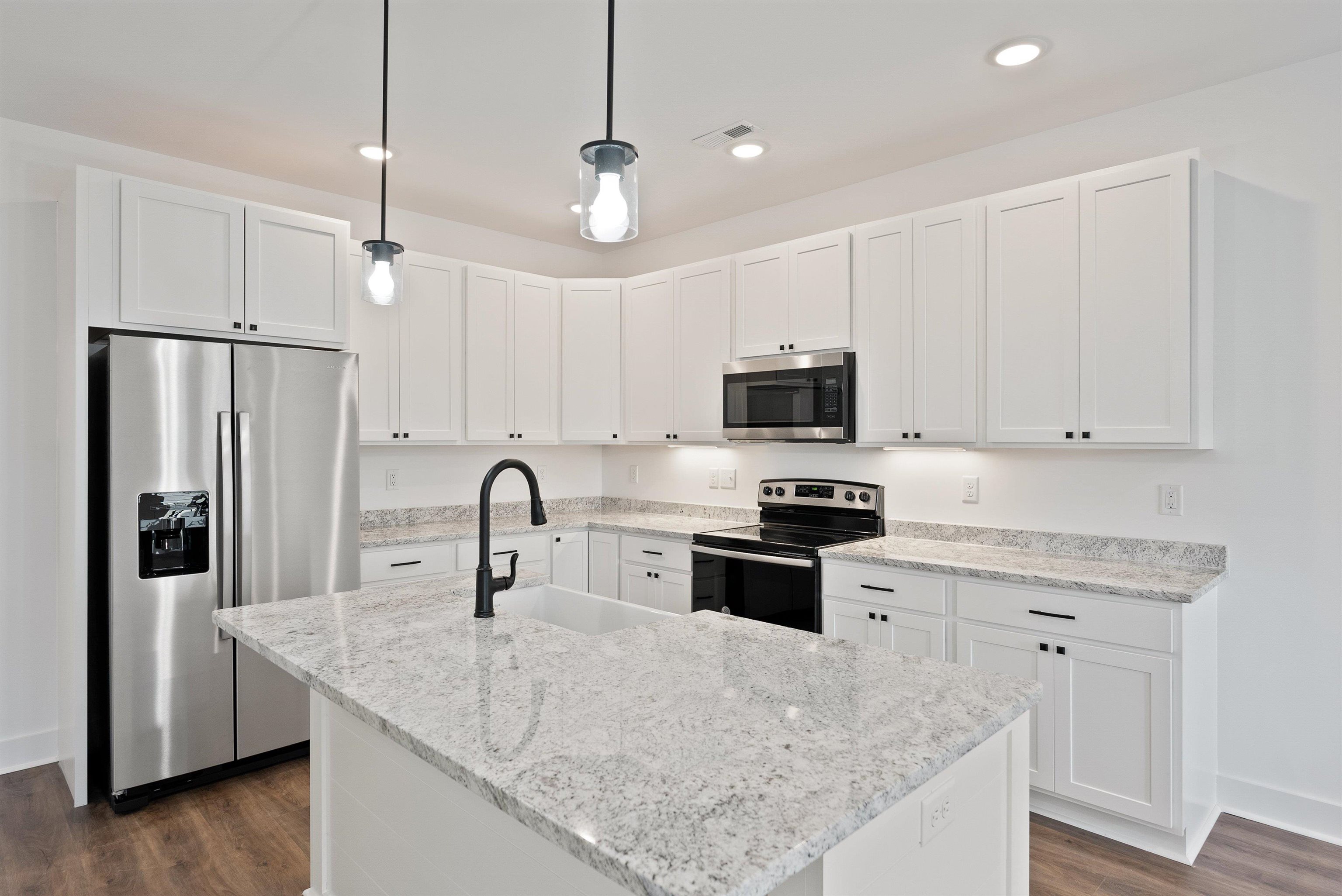 25 Barnyard Circle Bridgewater, VA 22812 - Photo 28 of 45 a kitchen with stainless steel appliances granite countertop a sink a stove a refrigerator and island with wooden floor