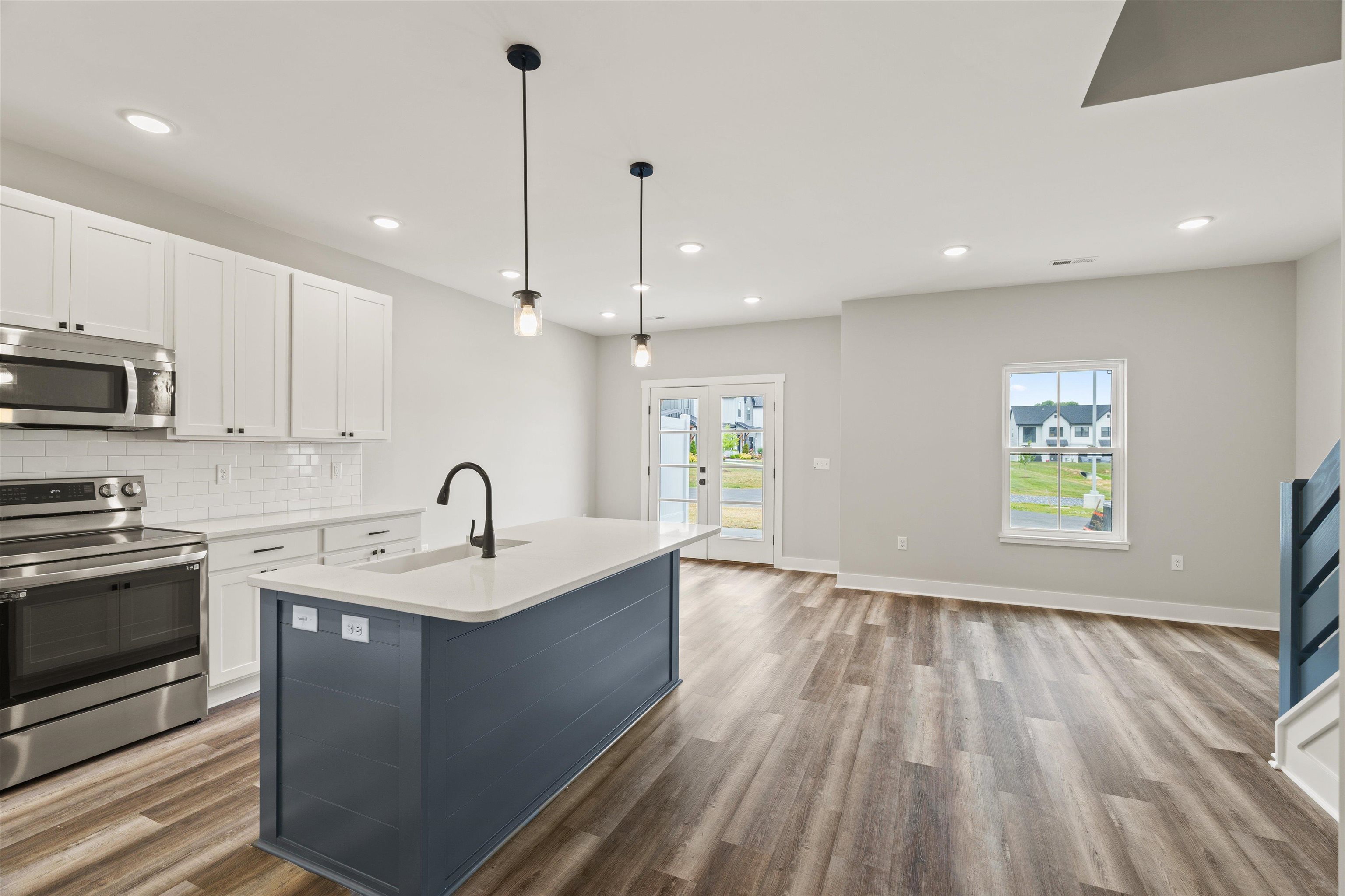 25 Barnyard Circle Bridgewater, VA 22812 - Photo 6 of 45 a kitchen with kitchen island white cabinets appliances and a window