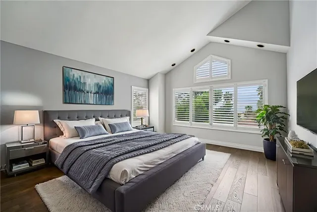 a spacious bedroom with bed and a large window
