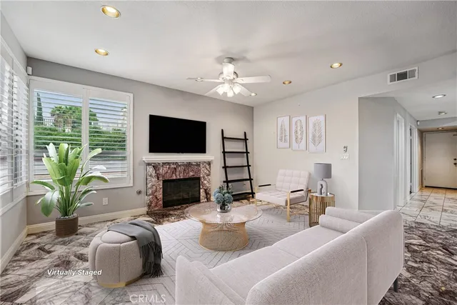 a living room with fireplace furniture and a flat screen tv