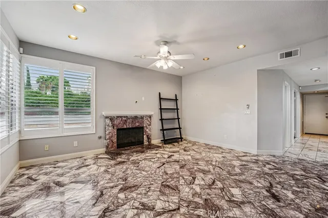 a view of a livingroom with a fireplace window and a fireplace