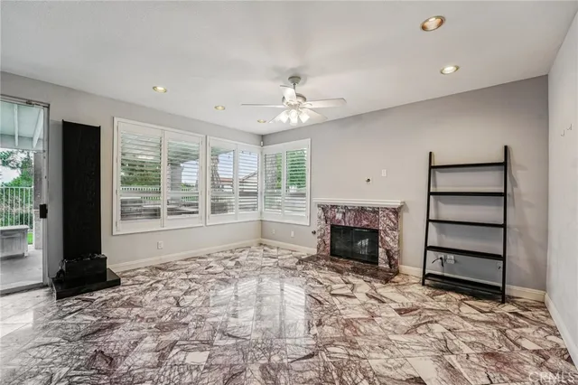 wooden floor fireplace and windows in an empty room