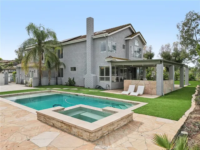 a view of a house with a yard and a patio