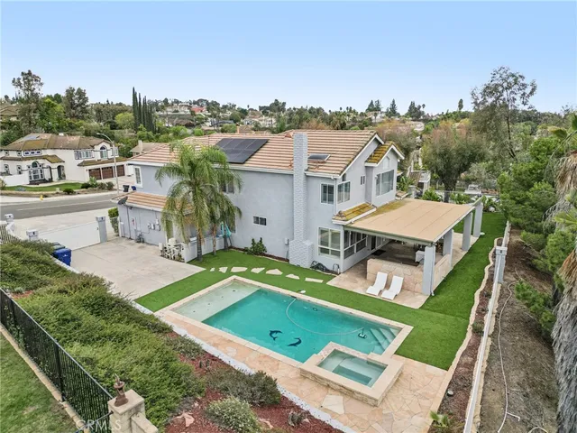 a view of a house with a backyard