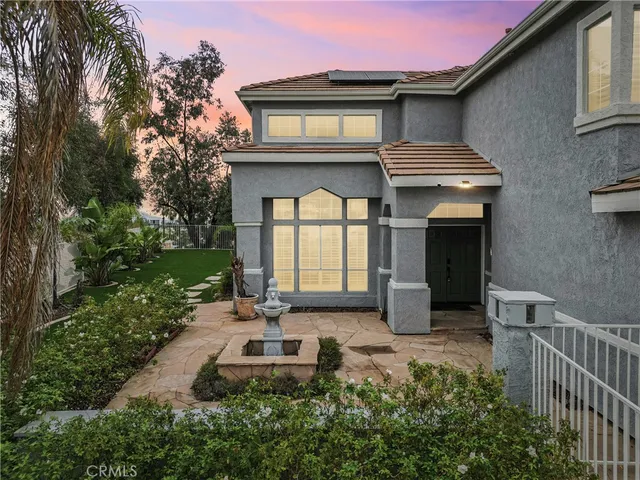 a front view of house with yard and outdoor seating