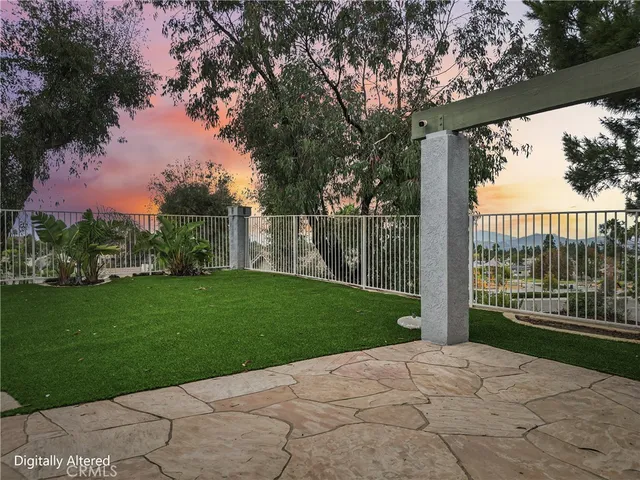 a view of a chair and table in backyard of the house