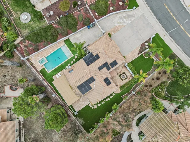 an aerial view of residential houses with outdoor space and trees