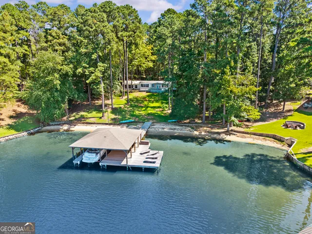 a wooden bench sitting in the middle of a yard