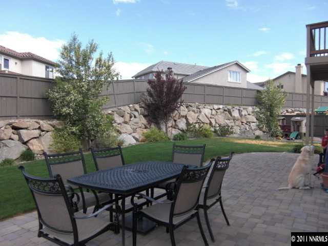 14044 Tagor Road Reno, NV 89521 - Photo 11 of 12 a view of a patio with table and chairs potted plants with wooden floor
