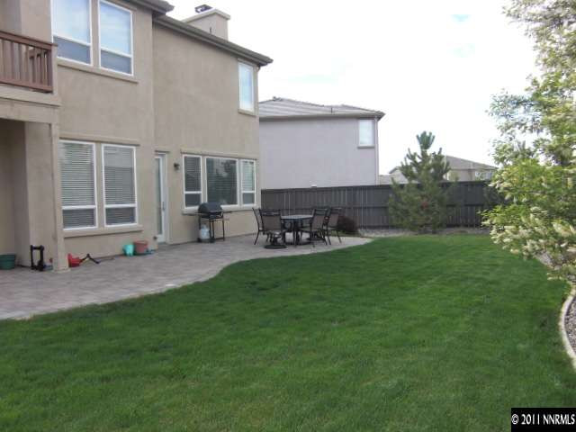 14044 Tagor Road Reno, NV 89521 - Photo 12 of 12 a backyard of a house with table and chairs