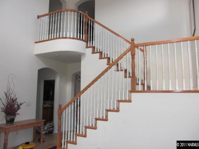 14044 Tagor Road Reno, NV 89521 - Photo 6 of 12 a view of staircase with lots of frames on wall and a potted plant