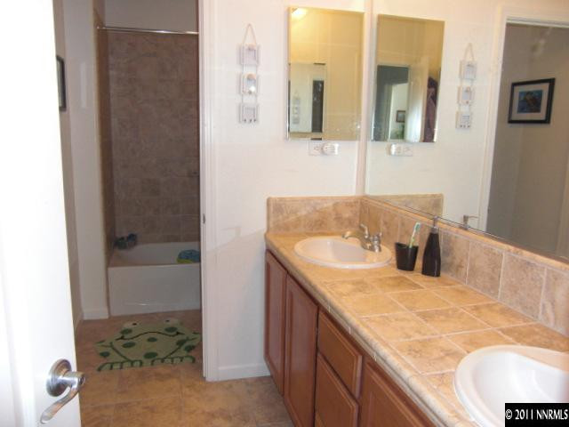 14044 Tagor Road Reno, NV 89521 - Photo 8 of 12 a bathroom with a granite countertop sink and a mirror