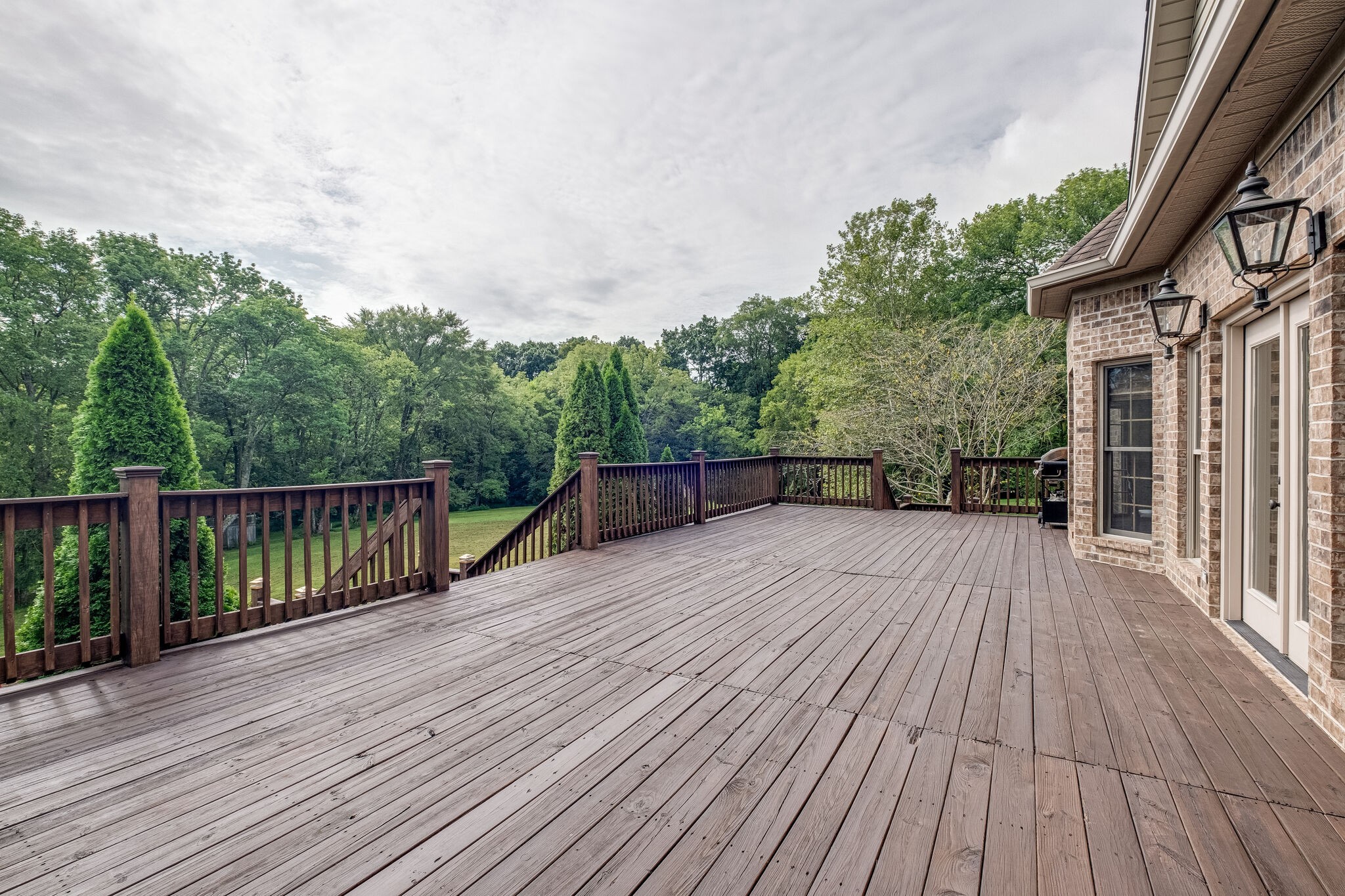1177 Palmer Road Lebanon, TN 37090 - Photo 27 of 29 a balcony with wooden floor and fence next to a yard