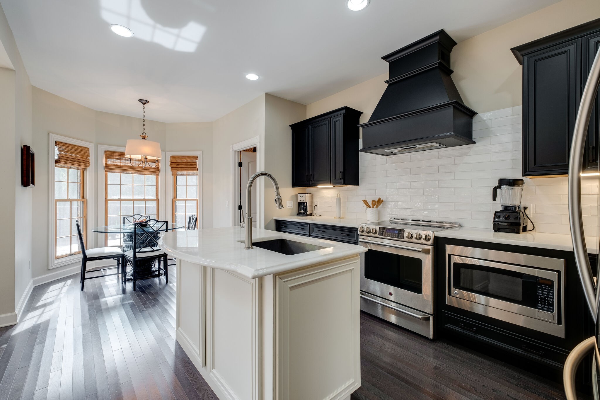 1177 Palmer Road Lebanon, TN 37090 - Photo 10 of 29 a kitchen with stainless steel appliances a stove a sink dishwasher a microwave oven and a dining table with wooden floor