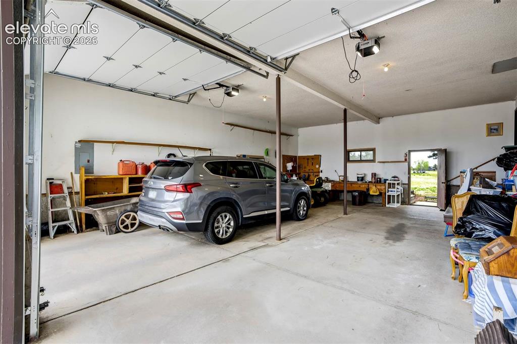 7585 Ponca Road Colorado Springs, CO 80908 - Photo 39 of 49 OVERSIZED, can fit 4 cars 2 on each side. Tall garage doors measure 9'10" x 8'8" each.