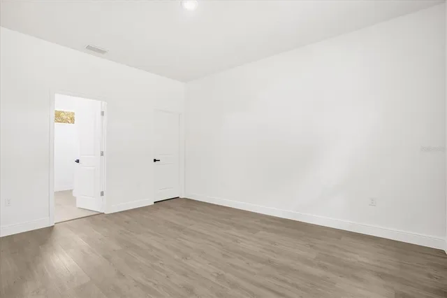 a bedroom with a bed and a potted plant