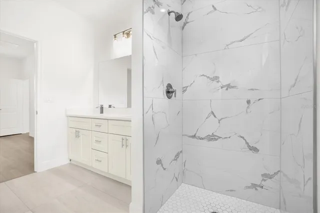 an empty room with wooden floor and window