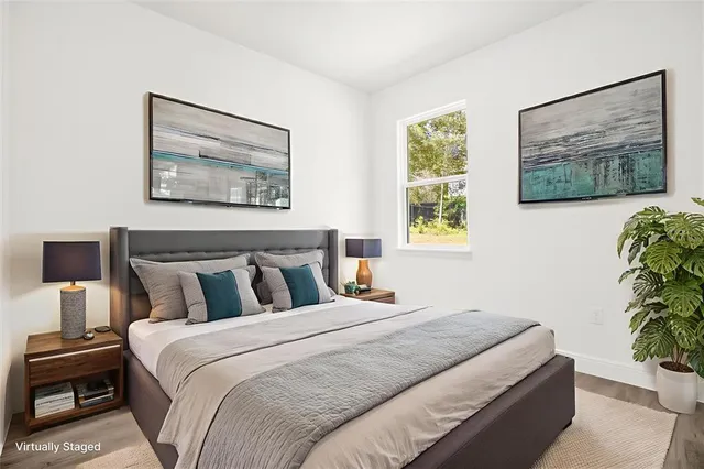 a bedroom with a bed and a potted plant