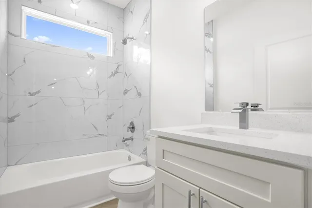 a bedroom with a large bed and a potted plant