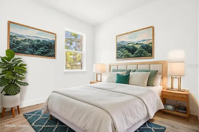 a bedroom with a bed and a potted plant
