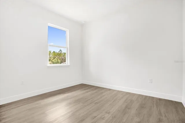 a bedroom with a bed and a potted plant