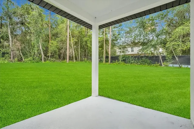 a view of an house with backyard space and balcony