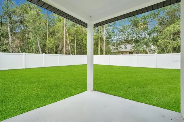 an aerial view of residential houses with outdoor space and street view