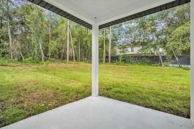 an aerial view of a house with yard swimming pool and outdoor seating